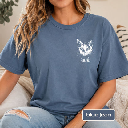 A woman wearing a blue crewneck t-shirt with a white cat face graphic and the name 'Jack' printed below it. The image includes a 'blue jean' color label overlay at the bottom right.
