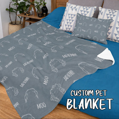 Gray custom pet blanket spread across a bed with pet outlines and names including Moo and Bad Bunny