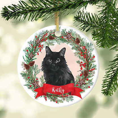 Round ceramic ornament featuring a black cat portrait, red berries, greenery, and Kathy name banner