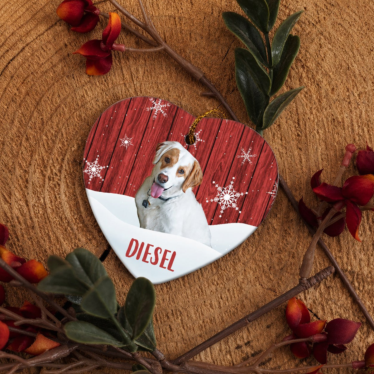 Heart-shaped pet ornament with a smiling dog portrait, red woodgrain, snowflakes, and the name Diesel