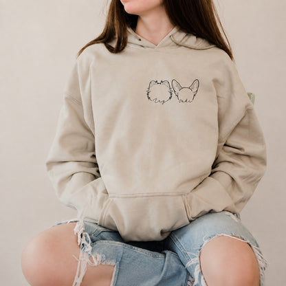 Cream hoodie with two black pet ear outline portraits and handwritten names