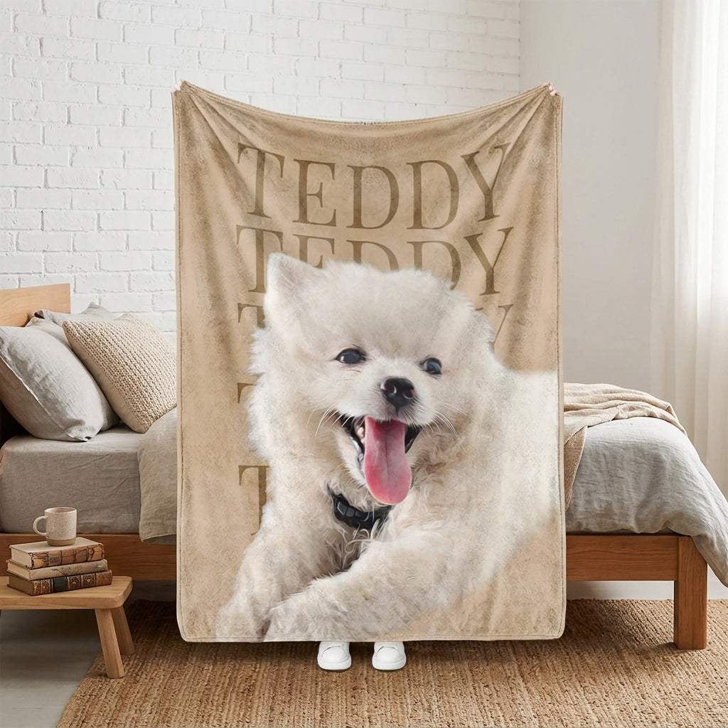 Personalized beige pet blanket featuring a fluffy white dog portrait and the repeated name Teddy
