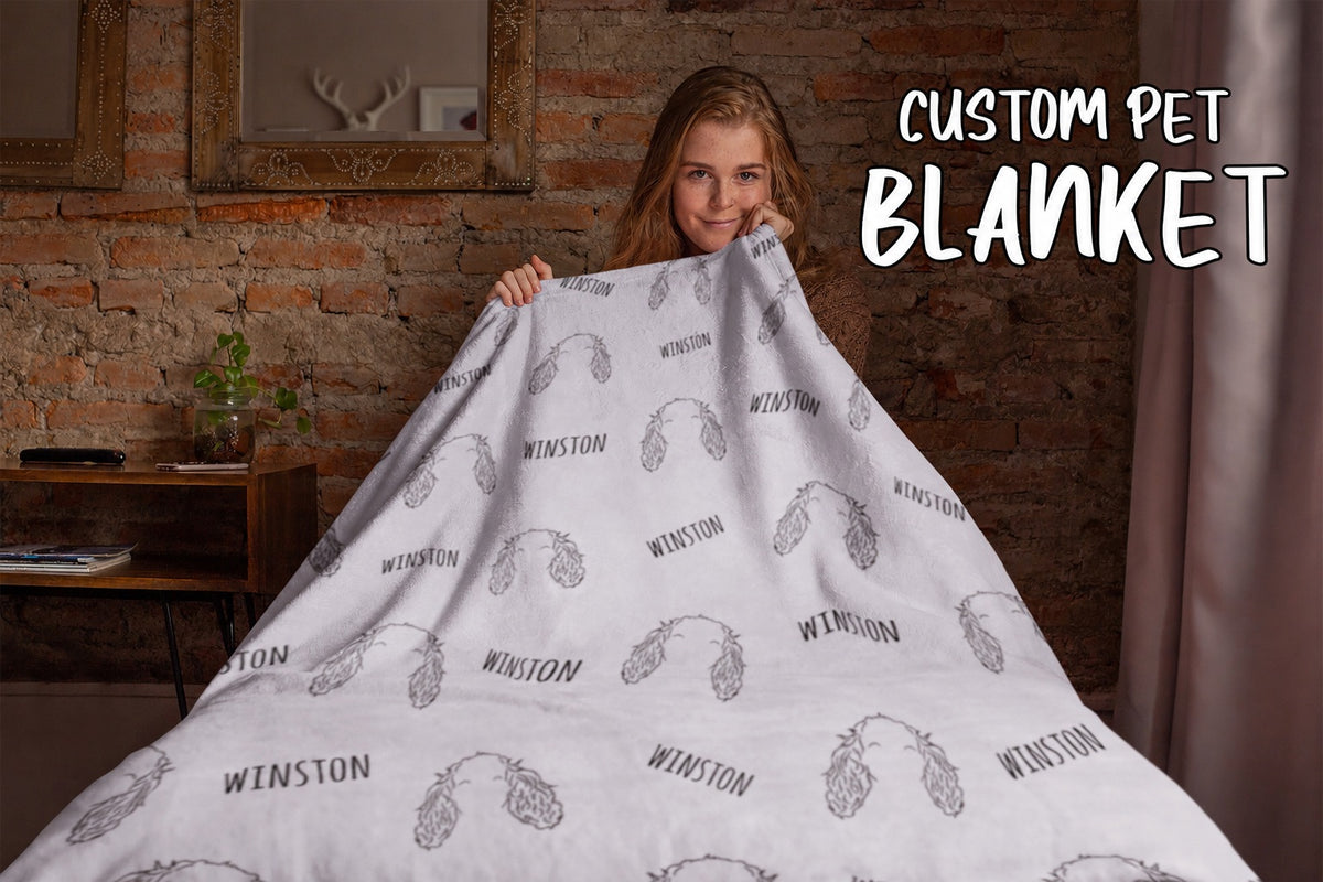 White personalized pet blanket with repeated floppy-ear line-art portraits and Winston names