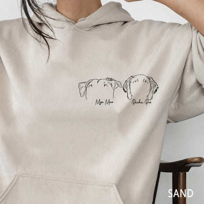 Sand hoodie close-up showing two minimalist pet outline portraits with names