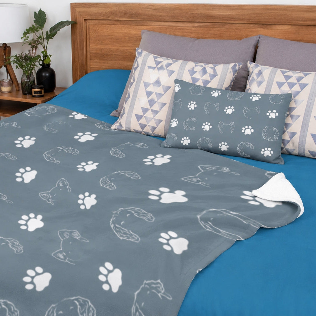 Close view of gray personalized blanket with repeated pet ear outlines and paw prints