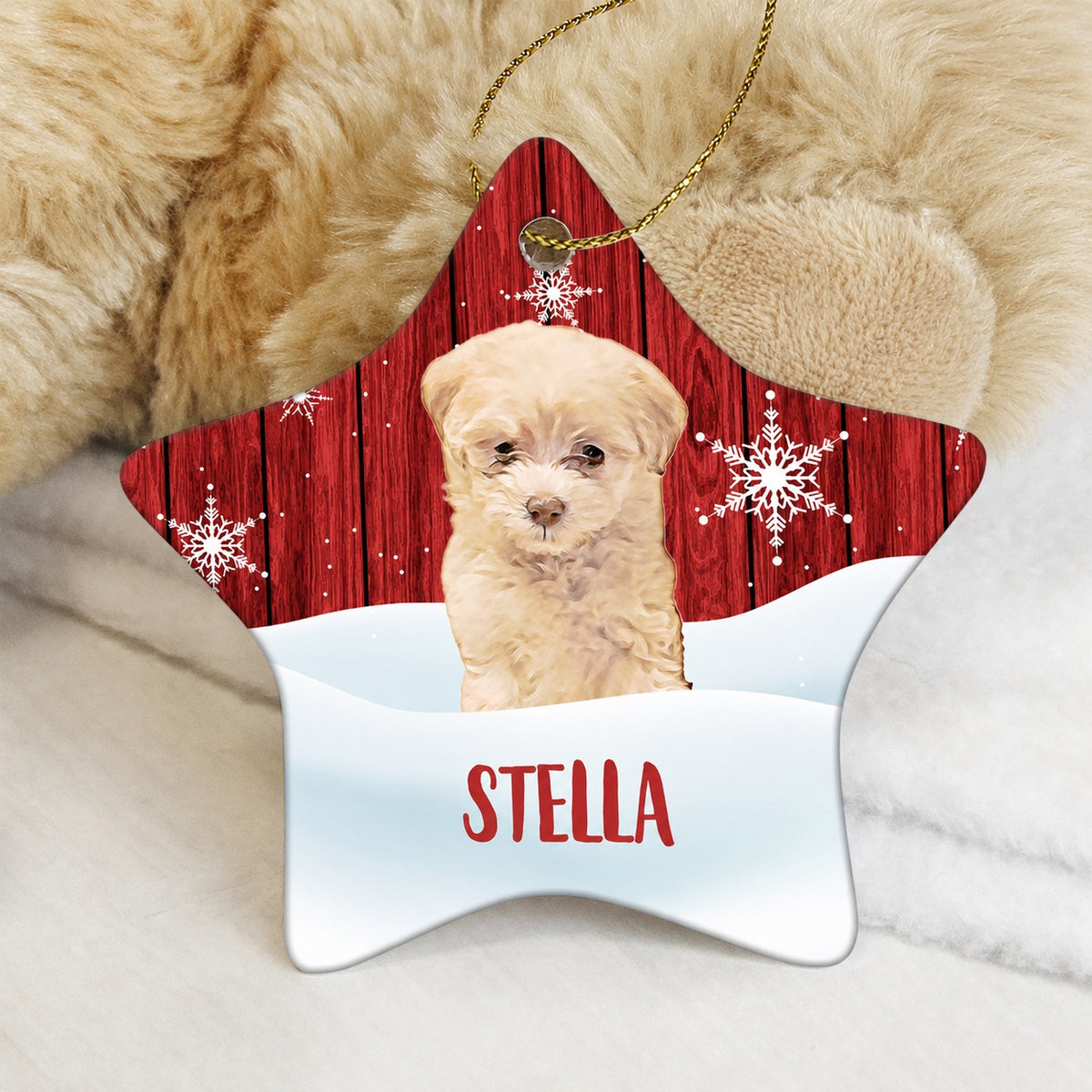 Star-shaped pet ornament with a small cream-colored dog portrait, snowy scene, and the name Stella