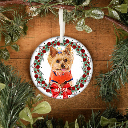 Round personalized ornament with a small Yorkshire terrier in a red berry wreath