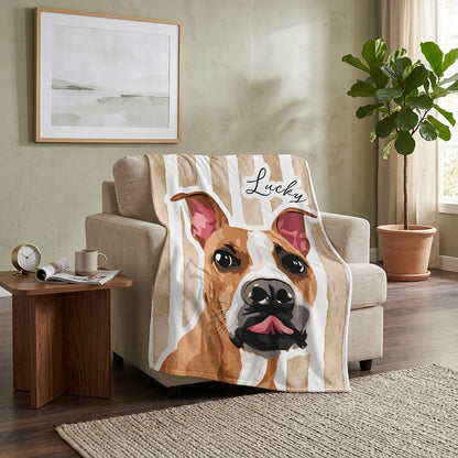 Personalized watercolor-style bulldog blanket with the name Lucky draped over a living room chair
