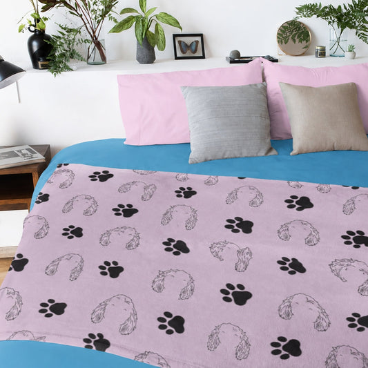 Pink custom pet blanket with floppy-eared dog outlines and black paw prints