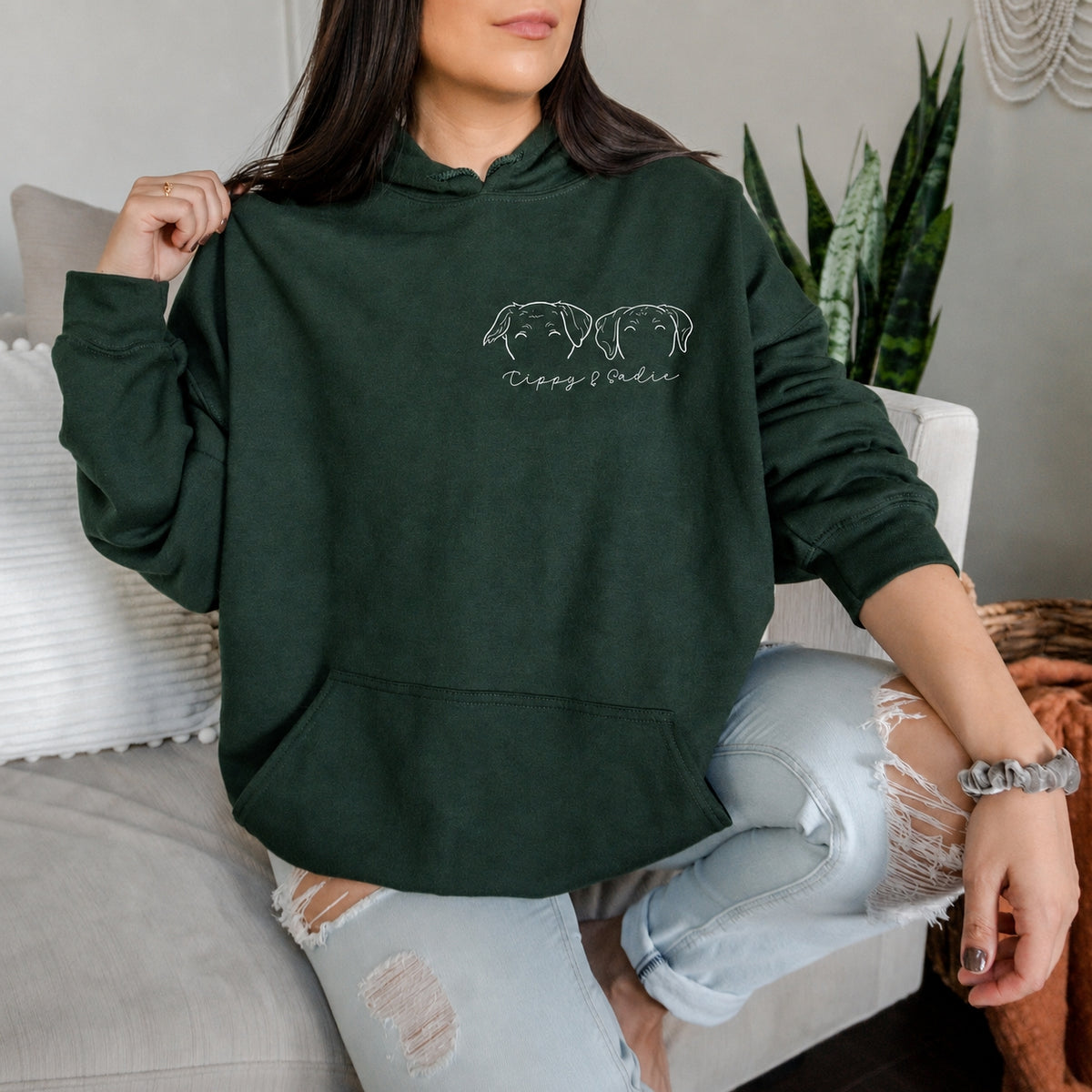 Forest green hoodie with two white dog outline portraits and the names Tippy and Sadie