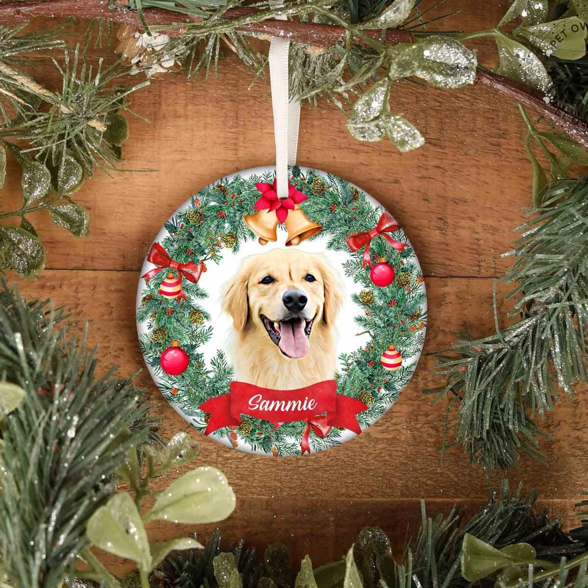 Round personalized pet ornament showing a golden dog named Sammie among holiday greenery