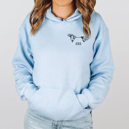 Light blue personalized pet hoodie with two illustrated pet profiles and the name Biber